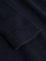 Close-up of the BGgreg L/S Grandad shirt by Blue de Gênes in Dark Navy, highlighting the long sleeve cuff with visible stitching and knit details on the textured cotton fabric.
