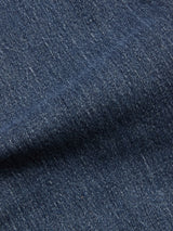 Close-up of the blue denim fabric highlights the texture and weave pattern, with visible diagonal lines and subtle color variations—perfectly showcasing the premium comfort stretch denim featured in our Blue de Gênes BGvinci Striker Jeans - Dark Distress regular fit jeans.