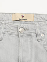 Close-up of BGgiacomo Color Jeans - Dolphin Grey by Blue de Gênes, in rigid denim with a metal shield button, belt loops, and a beige waistband label featuring the red and white shield and brand name.