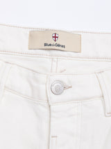 Close-up of the waistband and button on BGvinci Bianco Jeans - White by Blue de Gênes, featuring the signature red and white shield logo above the front pocket and on the button, crafted from comfort stretch denim.