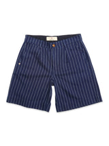 The BGcupra Toll Shorts - Navy Stripe by Blue de Gênes feature classic cotton navy shorts with white vertical pinstripes, front pleats, side pockets, and a brown button—perfect for relaxed workwear style.