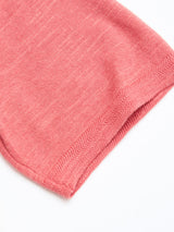 Close-up of the hem of the BGwally Diamond Polo in Coral by Blue de Gênes, featuring a pink diamond-knit pattern in a soft cotton linen blend, shown against a white background.