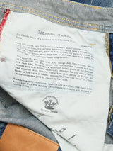 Close-up of BGgiacomo Tim Jeans - Antique wash by Blue de Gênes, showing a printed inner label about the jeans' history and inspiration, with visible stitching and rigid denim fabric. Made in Italy.