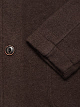 Close-up of the Kojima Wool Jacket - Chocolate by Blue de Gênes, showing the brown boiled wool sleeve with a black and brown button and precise stitching that highlights its expert craftsmanship.