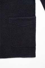 Close-up of the Blue de Gênes Kojima Wool Jacket - Navy, made from dark boiled wool, featuring a large rectangular front pocket with visible stitching against a plain white background.