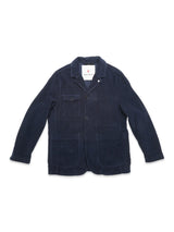 The Masami Cord Blazer - Navy by Blue de Gênes is a navy corduroy blazer featuring a button closure, three front pockets, and a collar. This garment-dyed workwear piece is displayed flat on a white background.