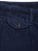 Close-up of the Etsu Cord Chino - Navy by Blue de Gênes, featuring a textured waistband, a flap pocket with a black button, and distinctive vertical ridges of 7-wale corduroy fabric in a relaxed regular fit.