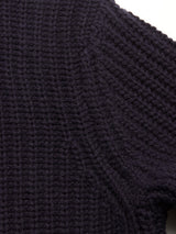 Close-up of the Yomaha Halfzip Knit in Navy by Blue de Gênes, featuring detailed texture and stitching on its dark, ribbed knit fabric.