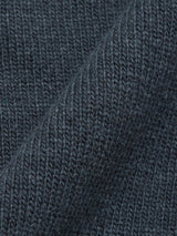Close-up of the Nuvali Polo Cardigan in Dark Slate by Blue de Gênes, showing detailed dark gray wool-blend knit texture with a diagonal fold—ideal for men's layering.