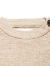 Close-up of the neckline of the Toyama Knit L/S - Oat by Blue de Gênes, featuring a ribbed collar and brown button detail on the right shoulder, beautifully knitted in Denmark.