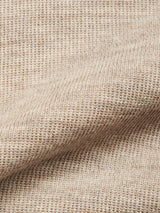 Close-up of the soft, ribbed knit fabric in oat shade and visible weave pattern of the Blue de Gênes Toyama Knit L/S crewneck sweater, crafted in Denmark from Merino wool.
