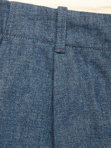Close-up of the Shogun Fano Pant in Denim Blue by Blue de Gênes, highlighting the heavy cotton waistband, belt loop, and the upper part of the pant leg against a light background.