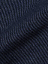 Close-up of the navy Menzo Olanda Chino by Blue de Gênes, featuring a textured, diagonal weave cotton blend fabric and a visible crease along the tapered leg.