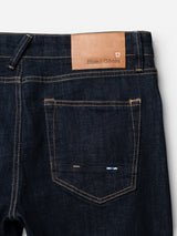 Close-up of the back pocket and waistband of BGvinci Girisha Rinse Jeans - Rinse Wash by Blue de Gênes, showing orange stitching on comfort stretch denim and a tan leather patch with the brand logo.