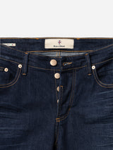 A close-up of BGvinci Pala Dark V2 Jeans by Blue de Gênes in dark blue stretch denim, featuring three metal buttons, orange stitching, and a branded inner label. Expertly crafted in Italy for a premium touch.