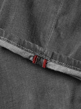 A close-up of the BGrepi Giulio Light V2 Jeans in grey denim by Blue de Gênes highlights the detailed stitching and texture, with a seam featuring two small red stitches near the edge.