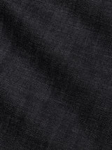 Close-up of the BGgiacomo Selvedge V2 Jeans - Raw Denim by Blue de Gênes, showcasing black selvedge denim with a distinctive diagonal weave, visible texture, and refined highlights and shadows—hallmarks of rigid denim jeans crafted with exceptional quality, reminiscent of relaxed loose fit Italian-made styles.