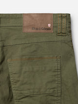 Close-up of the BGpaulo Pavia 1 V2 Chino - Army from Blue de Gênes, featuring green cotton stretch fabric, detailed stitching, and a brown leather patch with the Blue de Gênes name and a small shield logo above the back pocket. These chinos blend vintage military-inspired style with modern comfort.