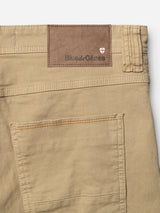 Close-up of BGpaulo Pavia 1 V2 Chino - Khaki by Blue de Gênes, made from stretch cotton, featuring a back pocket, brown leather patch embossed with the brand, and a red and white shield logo.