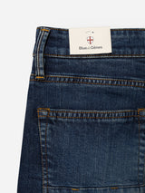 Close-up of the BGvinci Hermina Jeans - Med Used by Blue de Gênes in a regular fit style, showcasing yellow stitching and the signature brand tag tucked into the waistband. Made from comfort stretch denim to ensure ease of movement.