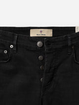 Close-up of the waistband and button fly of the BGvinci TrueBlack Jeans in black denim, a regular fit style by Blue de Gênes. Crafted from comfort stretch fabric with visible stitching and metal buttons, the jeans feature an inner waistband label displaying the Blue de Gênes name along with their shield logo.