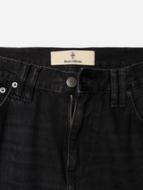 Close-up of the waistband and zipper area of BGmarco Connor Jeans - Black Denim Used by Blue de Gênes, showcasing visible stitching, a metallic button, and a partially visible inner label. These jeans offer a relaxed fit and are made from 100% cotton denim.