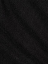 A close-up of black fabric with a subtle diagonal weave pattern and soft texture, showing faint lines and shadows across the surface—crafted from 100% cotton denim, this material embodies the comfort and timeless appeal of the Blue de Gênes BGmarco Connor Jeans in Black Denim Used.