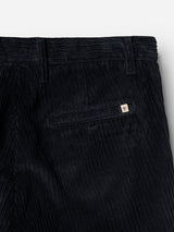 Close-up of the Blue de Gênes BGpalco Cord Chino in Navy, showcasing its relaxed fit and distinctive corduroy texture. A back welt pocket is detailed with a small rectangular logo tag above it, while the modern tapered leg silhouette enhances its contemporary appeal.