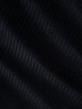 Close-up of navy corduroy fabric from the BGpalco Cord Chino by Blue de Gênes, revealing diagonal, textured ridges and a soft, velvety surface—hallmarks of premium men’s tapered corduroy trousers. The material exhibits a gentle sheen with subtle highlights and shadows, reflecting the quality fabrics characteristic of Blue de Gênes apparel.