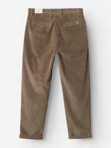 The BGpalco Cord Chino in Sepia Tint Brown by Blue de Gênes is pictured from the back, showcasing its belt loops, two back pockets, and a white label on the waistband. These relaxed fit corduroy trousers feature a tapered silhouette and are laid flat against a white background.
