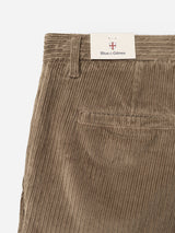 Close-up of the BGpalco Cord Chino in Sepia Tint Brown, featuring a back pocket and belt loop. The Blue de Gênes brand tag is attached above the waistband, highlighting these relaxed fit corduroy trousers with a tapered silhouette.
