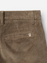Close-up of the BGpalco Cord Chino in Sepia Tint Brown by Blue de Gênes, showcasing the back pocket, belt loop, and a small stitched shield logo tag above the pocket, with a focus on their tapered silhouette.
