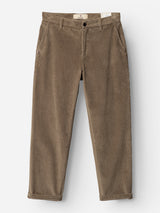 The BGpalco Cord Chino in Sepia Tint Brown by Blue de Gênes—relaxed fit corduroy trousers with side pockets, button closure, belt loops, and rolled cuffs, featuring a flattering tapered silhouette—laid flat on a white background.