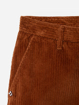 Close-up of Blue de Gênes BGpalco Cord Chino in Ginger Bread Orange, highlighting the waistband, belt loop, front pocket, and a small stitched logo near the pocket against a plain white background. These relaxed fit corduroy trousers feature a tapered silhouette for a contemporary look.