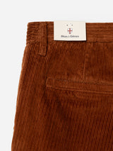 Close-up of the BGpalco Cord Chino in Ginger Bread Orange by Blue de Gênes, featuring a relaxed fit with a modern tapered silhouette, detailed with a back pocket and a signature brand tag tucked into the waistband.