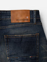 Close-up of a back pocket on the BGvinci Finlay Jeans - Vintage Wash by Blue de Gênes, featuring a brown leather patch with the brand’s name and a small shield logo near the waistband, highlighting the comfort stretch denim that delivers both style and ease.