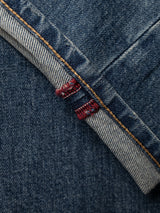 A close-up of the BGrepi Presley Jeans - Denim Blue by Blue de Gênes highlights a folded cuff with orange stitching and a subtle red thread detail on the seam, crafted from comfort stretch denim for all-day ease.