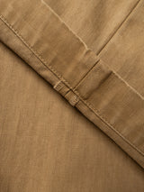 Close-up of tan herringbone-patterned fabric with a neat stitched seam and two small parallel stitches, featured on the Blue de Gênes BGmenzo Rory Chino in khaki.