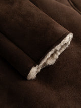 Close-up of the BGseras Shearling Coat in Dark Brown by Blue de Gênes, highlighting the rich brown suede sleeve and plush white shearling lining—showcasing the inviting texture and luxurious detail of this cold-weather essential.