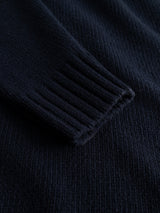 Close-up of the sleeve of the Blue de Gênes BGfraser Zip Knit in Dark Navy, highlighting the ribbed cuff and textured wool fabric.
