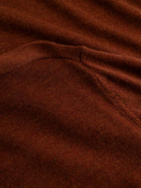 Close-up of the fine-gauge knit fabric in Ginger Bread Orange, highlighting the detailed stitching and seam work that showcase the rich texture and weave of the Blue de Gênes BGigor Polo Knit.