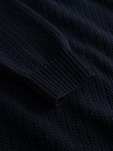 Close-up of the sleeve of the BGmurry Polo Knit - Dark Navy by Blue de Gênes, highlighting its ribbed cuff and textured knit pattern.