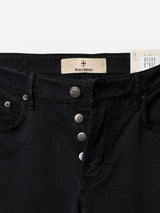 Close-up of the waist and buttons of a pair of navy BGvinci Iro Pant by Blue de Gênes, featuring metal buttons and a signature Blue de Gênes label. Crafted from comfort stretch twill for everyday ease, these regular-fit pants also display a partially visible white tag on the right side.