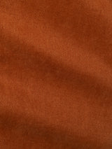 Close-up of ginger bread orange comfort stretch twill fabric with a diagonal weave pattern, highlighting its texture and fine lines. The surface appears soft and evenly colored, reflecting the durability and warmth characteristic of Blue de Gênes BGvinci Iro Pant.