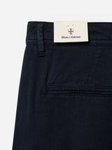 Close-up of BGmenzo Vecchio Chino in dark navy by Blue de Gênes, featuring comfort stretch fabric, a back pocket, and a cream brand tag with red and blue crest on the waistband—classic men's chinos with timeless style.