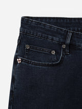 Close-up of the upper section of Blue de Gênes BGvinci Black OD Jeans in blue black denim, featuring comfort stretch and a front pocket with a small white and red shield emblem stitched on the coin pocket.