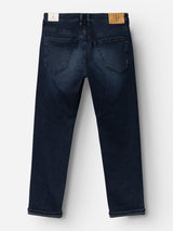 BGgiacomo BB Jeans by Blue de Gênes in blue black denim, shown from the back, feature two rear pockets, a tan leather patch on the waistband, and slightly rolled-up cuffs. Crafted from rigid denim, these jeans offer a classic straight-leg fit for timeless appeal.