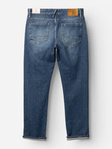 The BGvinci Break Jeans - Denim wash by Blue de Gênes are shown laid flat on a white background, displaying the dark blue regular fit from the back. Crafted from comfort stretch denim, these jeans feature two rear pockets, visible seams, and two waistband patches—one in white and one in tan.