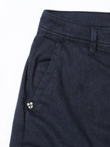 Close-up of the upper section of Blue de Gênes Menzo Olanda Chino - Navy, showcasing a side pocket, belt loop, and metal detail—classic cotton stretch chinos with a tailored fit.