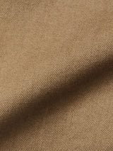 Close-up of Blue de Gênes BGpaulo Pavia 1 V2 Chino - Fungi, showcasing its light brown cotton stretch fabric with a soft, textured surface and subtle folds—highlighting the weave and vintage military-inspired style.